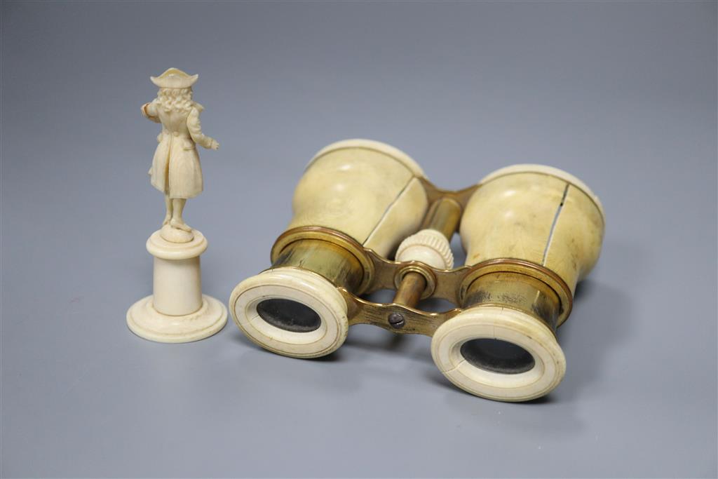 A pair of ivory binoculars and an ivory figure, height 9cm